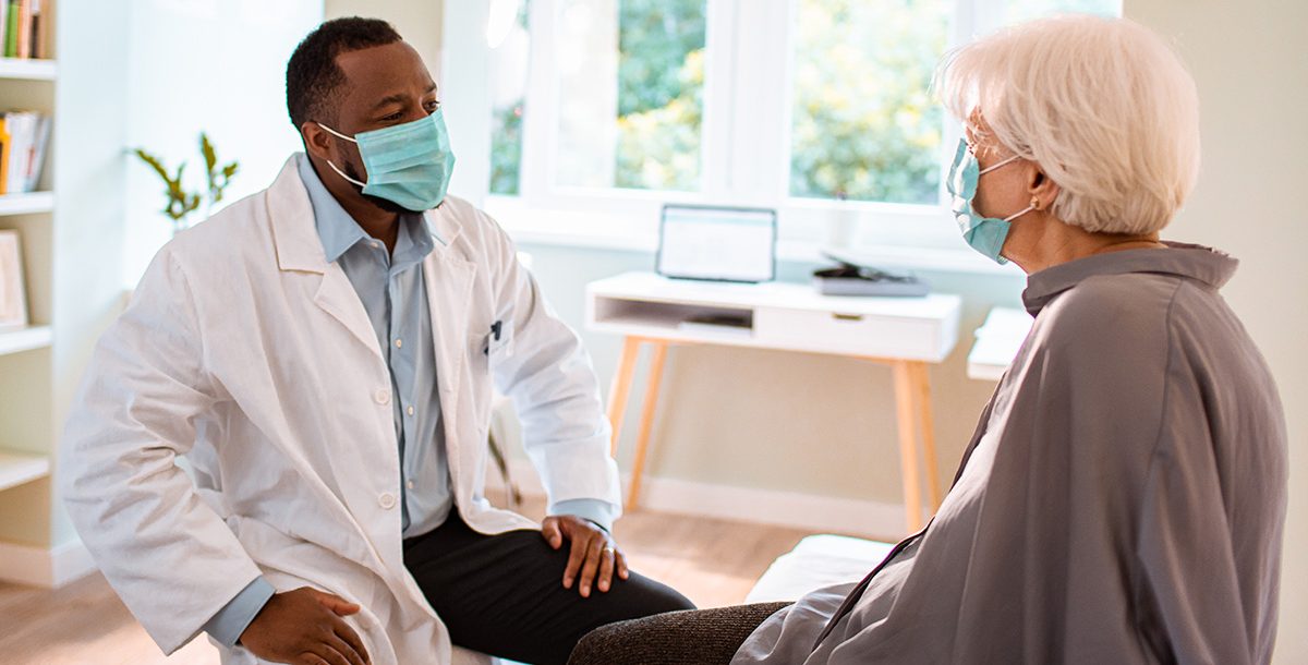 A man meeting with his primary care provider.