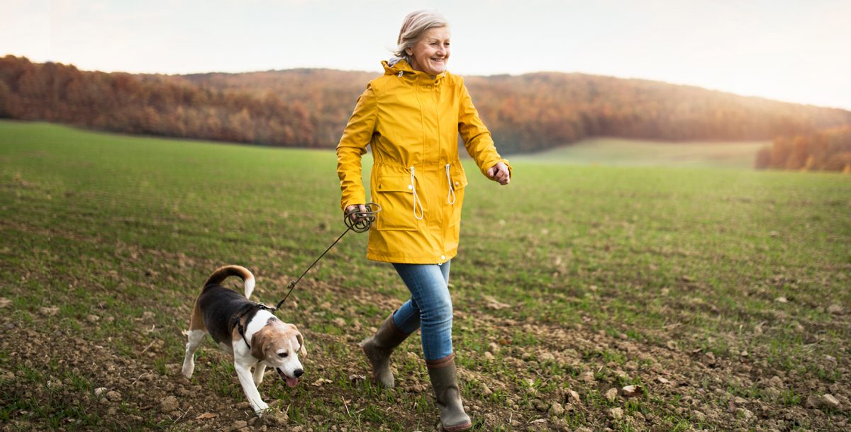 Woman walking outside with her dog.