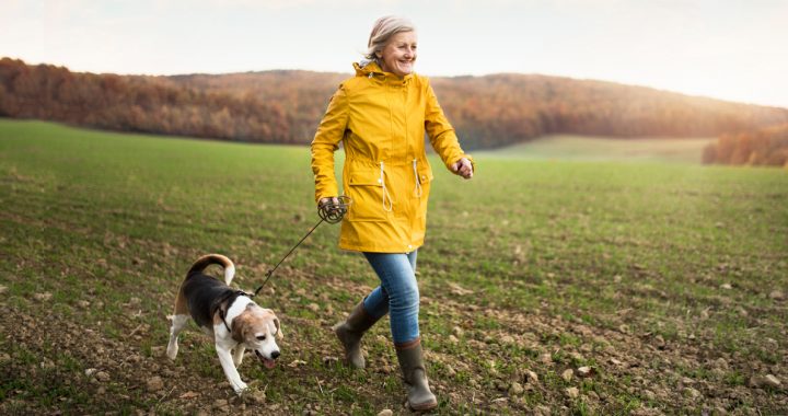 Woman walking outside with her dog.