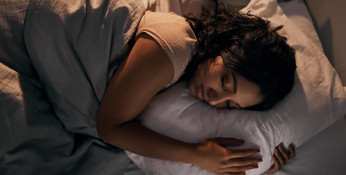 Woman sleeping in a dark room.