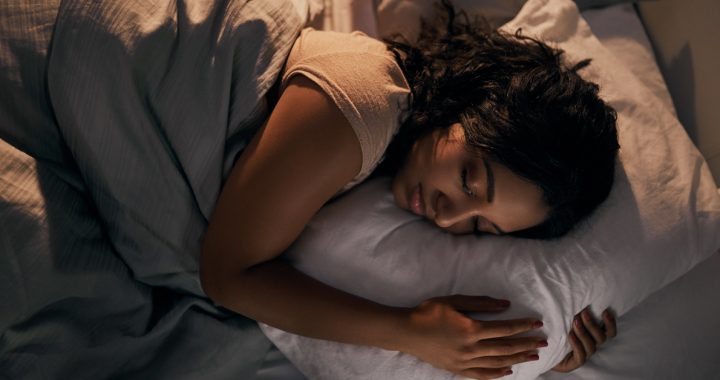 Woman sleeping in a dark room.