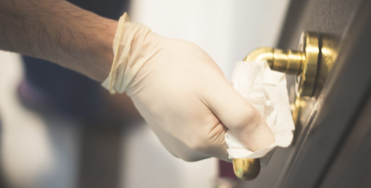 Individual cleaning and disinfecting a door handle at home