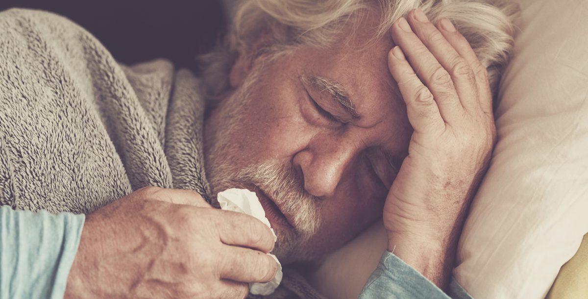 Sick man managing his illness symptoms at home