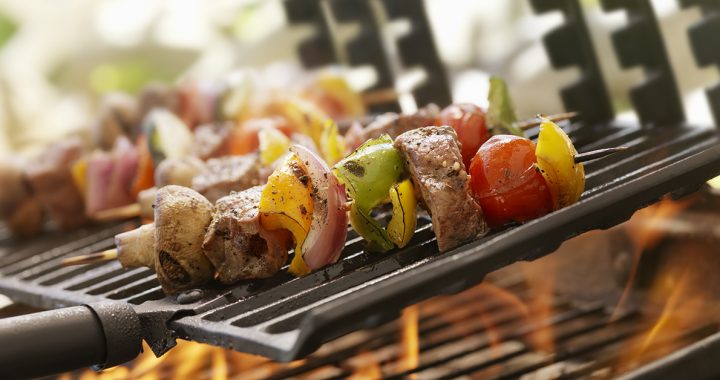 someone grilling healthy chicken kabobs during the summer