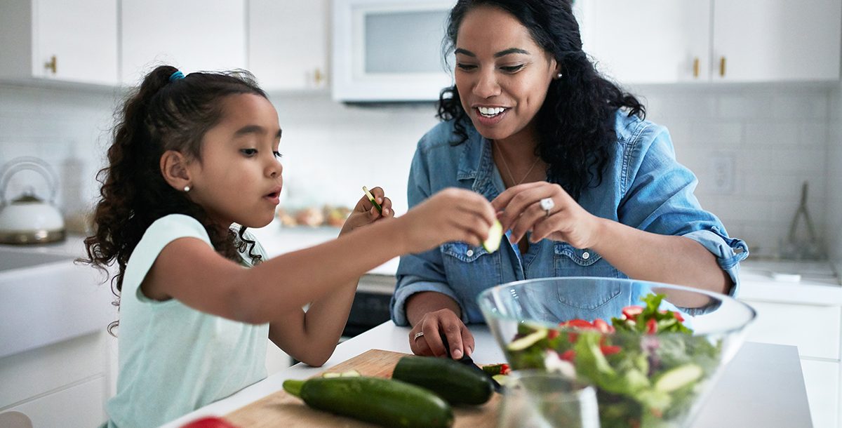 Mother cooking pantry recipes with daughter during COVID-19.