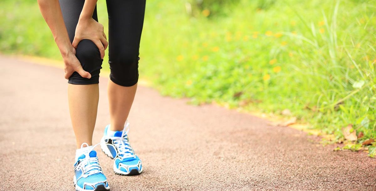 A person experiencing joint pain during the summer months.