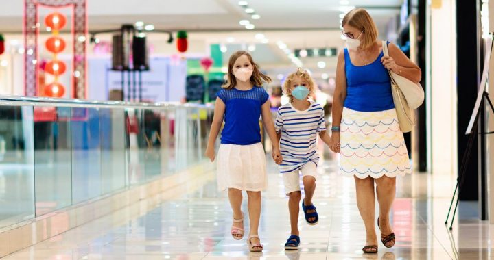 A family on a trip to the mall wearing face masks.