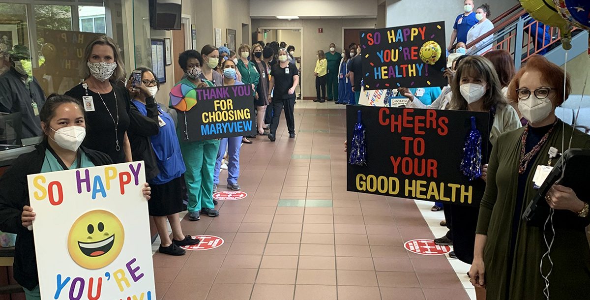 Staff members at Bon Secours Marvyiew Medical Center celebrating Mrs. Wilson's "Code Happy" celebration.