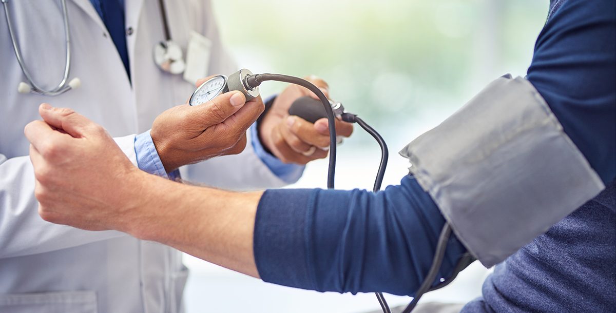 A person checking their blood pressure with their health care provider.