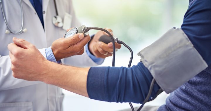 A person checking their blood pressure with their health care provider.