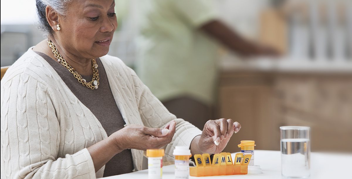 A woman managing her medications at home during COVID-19.