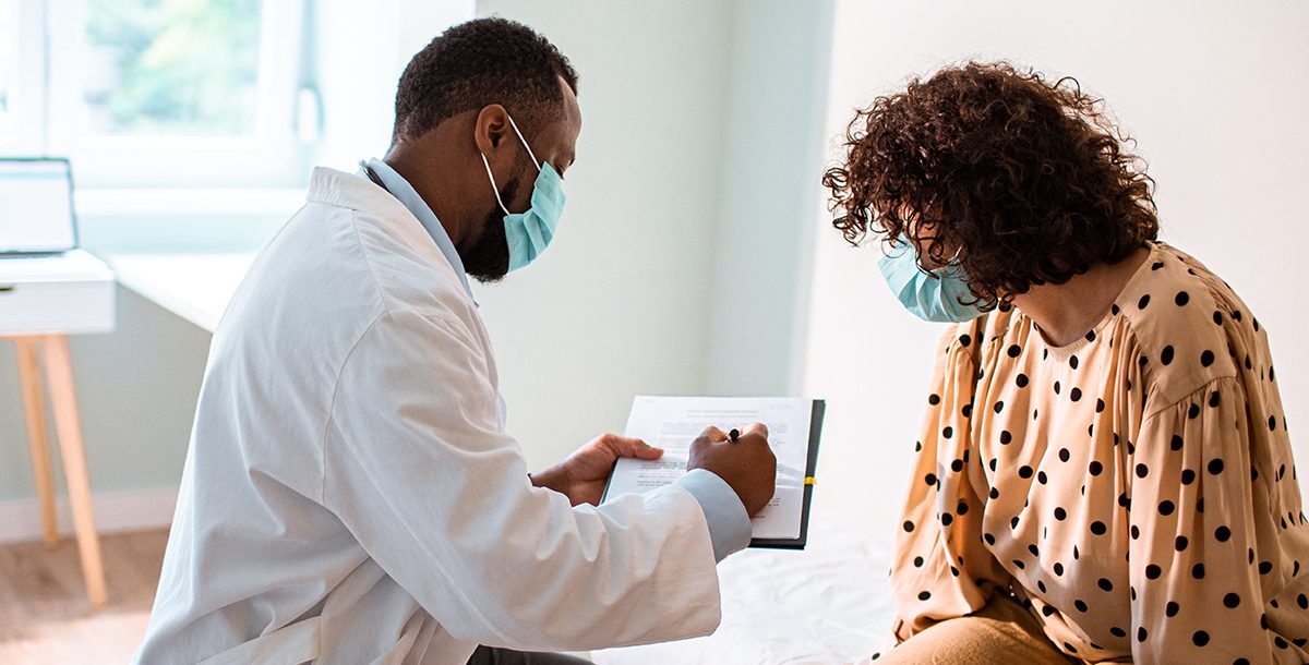 A woman meeting with her new primary care provider.