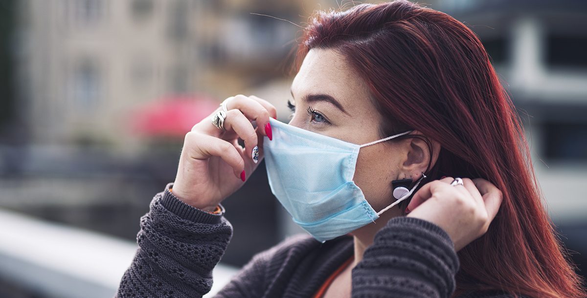 A woman wearing her face mask correctly during COVID-19.