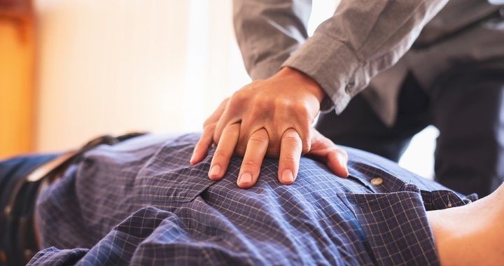 A person performing hands-only CPR.