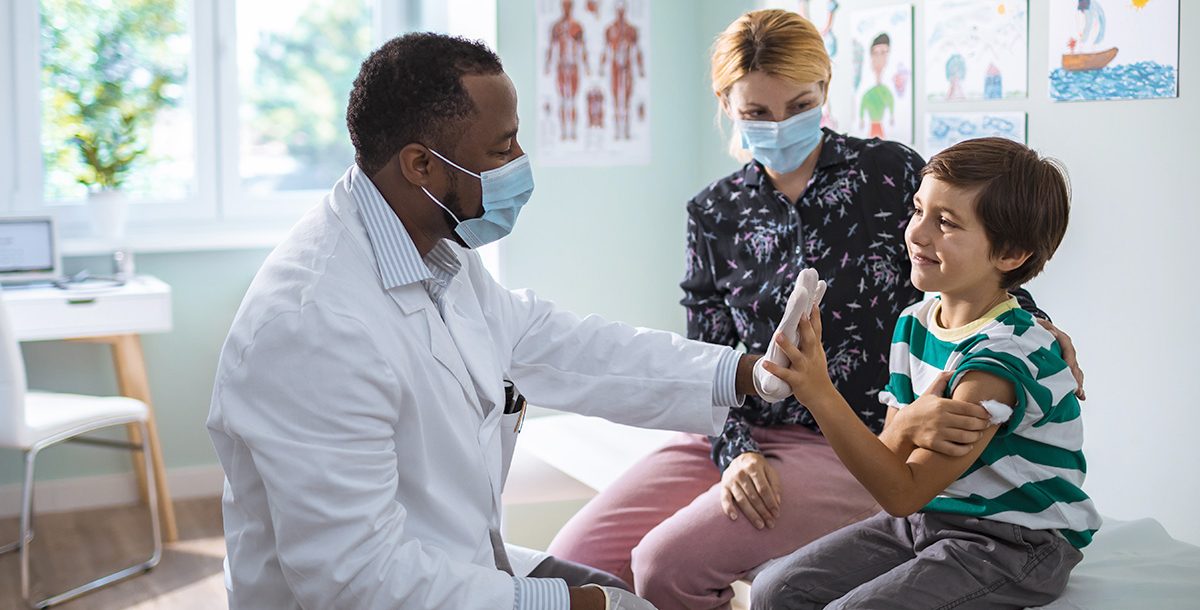 A pediatrician taking care of a child.