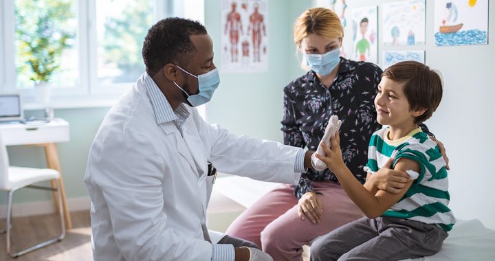 A pediatrician taking care of a child.