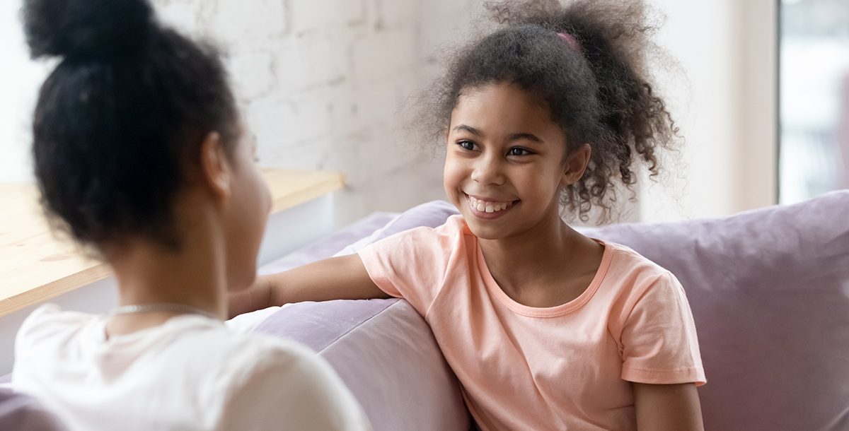 A mother talking to her daughter at home.