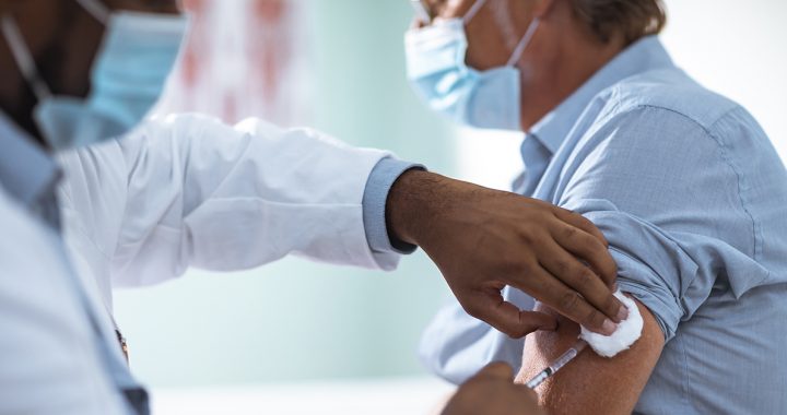 A patient getting a flu vaccine from their provider.