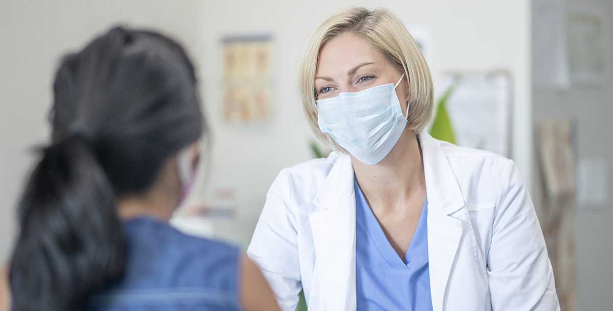 A health care professional speaking with a patient.