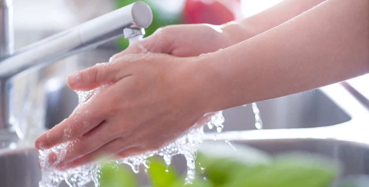 A person washing their hands.