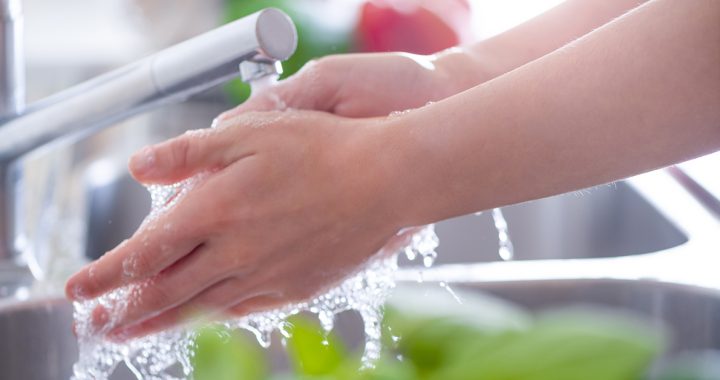 A person washing their hands.