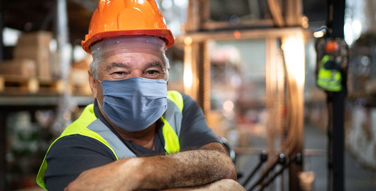 A man wearing his face mask while at work.