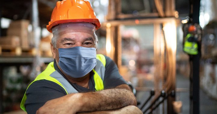 A man wearing his face mask while at work.