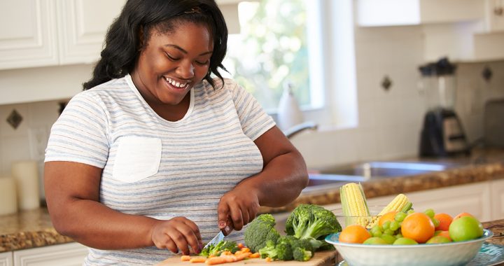 A woman cooking a healthy meal in her kitchen.