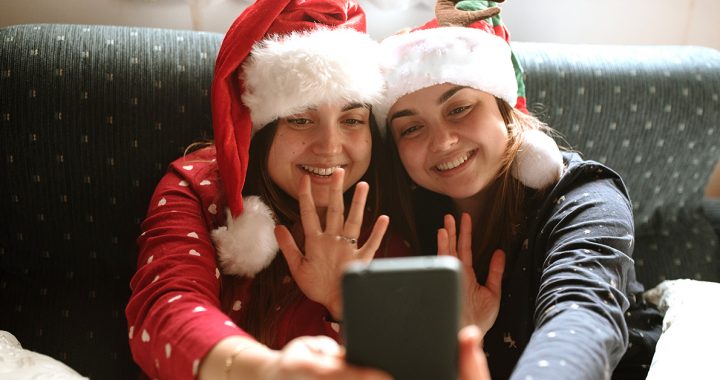 Two people enjoying a holiday video call.