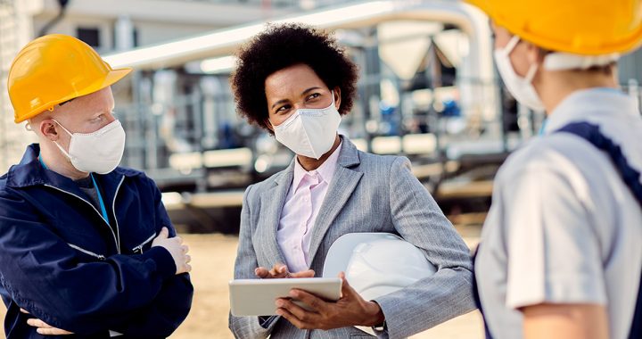 People wearing face mask while meeting in person.