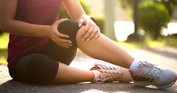 A woman experiencing a knee strain