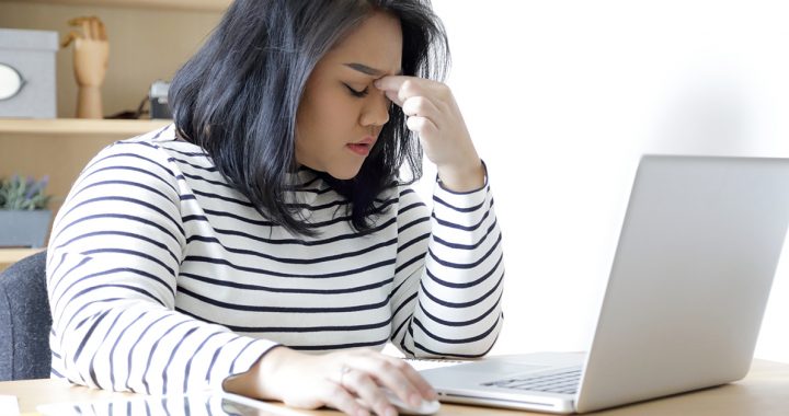 A person experiencing stress while working from home.