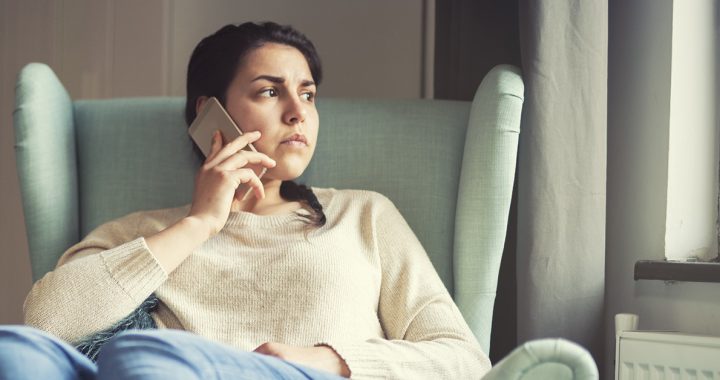 A woman participating in a therapy session over the phone.