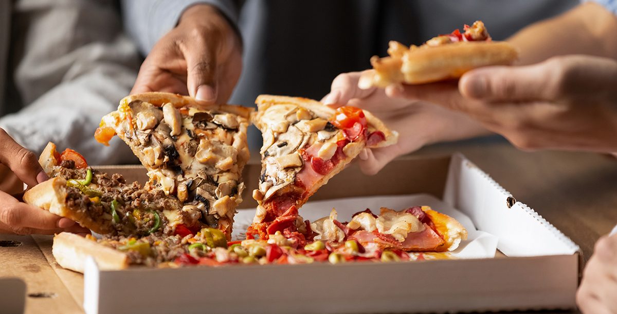 A family enjoying pizza takeout.