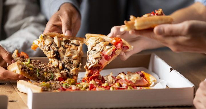 A family enjoying pizza takeout.