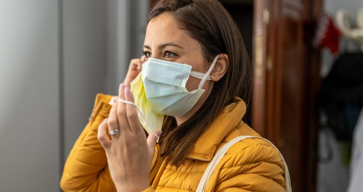 A woman wearing two face masks in public.