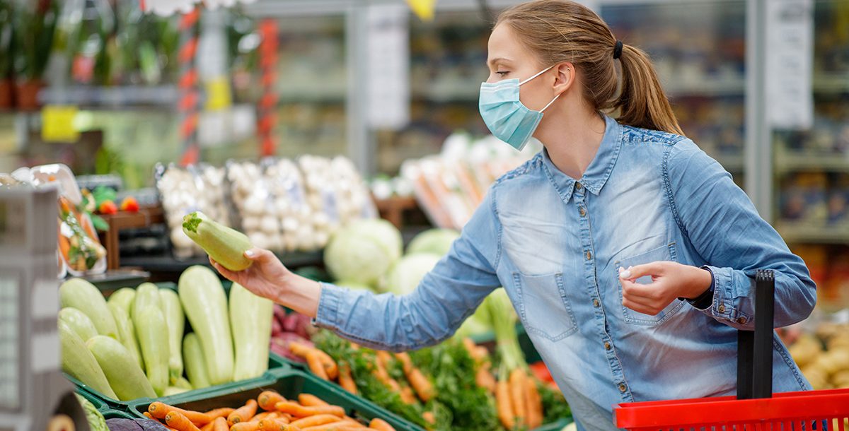 A woman enjoying a farmers market.