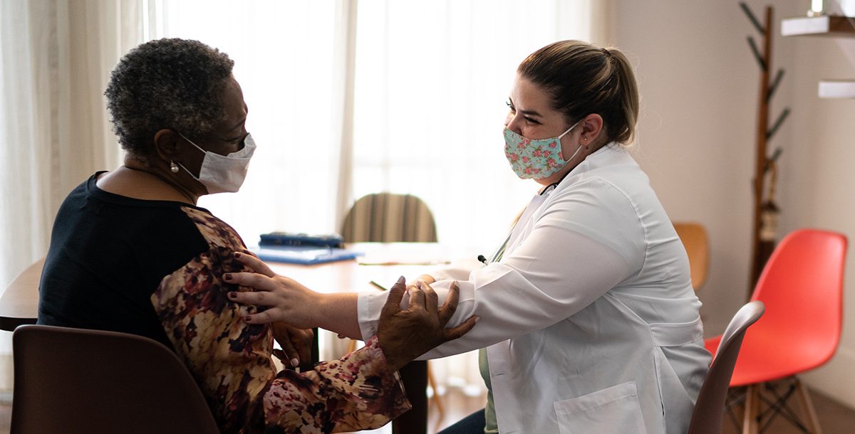 A woman meeting with her health care provider.