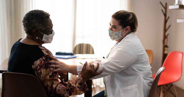 A woman meeting with her health care provider.