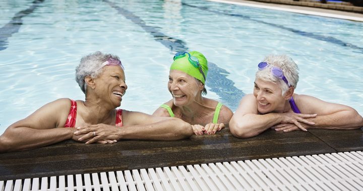 Three senior friends swimming together.