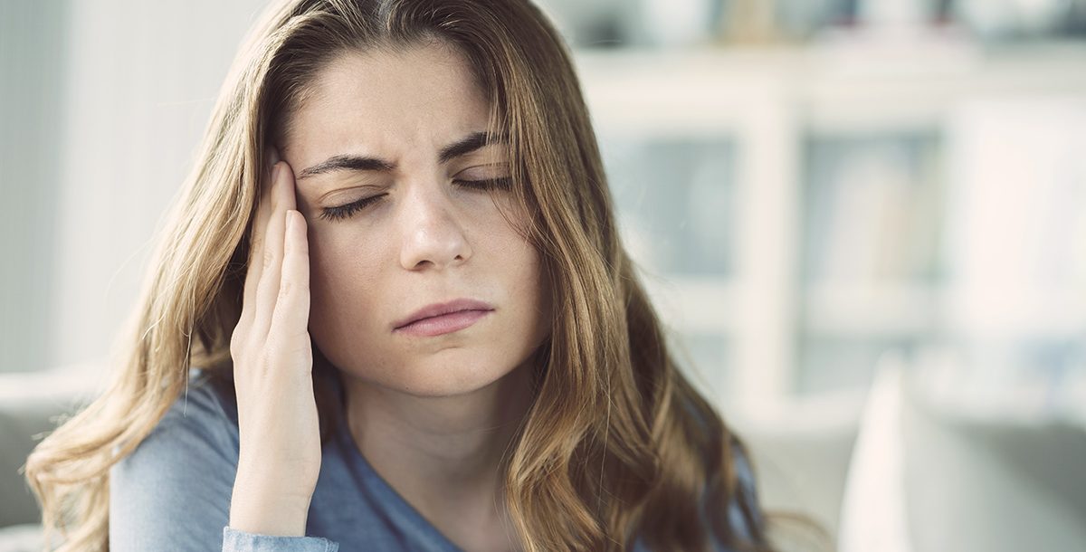 A woman experiencing side effects from her COVID-19 vaccine.