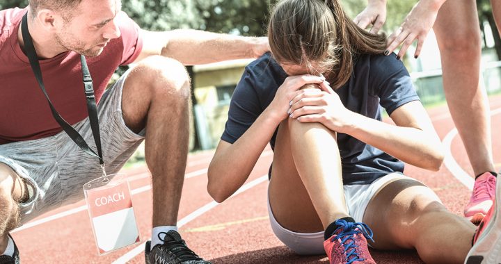 A woman experiencing a common summer injury from running.