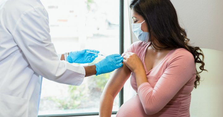 A pregnant woman getting her COVID-19 vaccine.