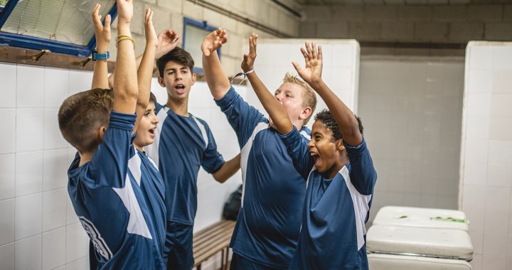 Student athletes in a locker room together.