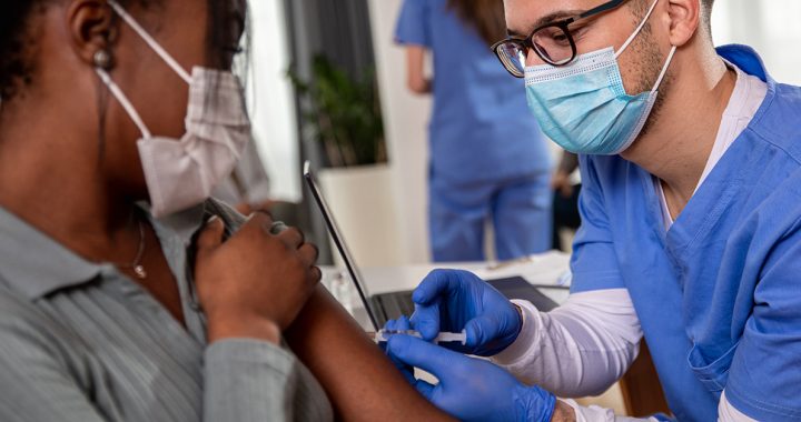 A patient getting their flu and COVID-19 vaccines.