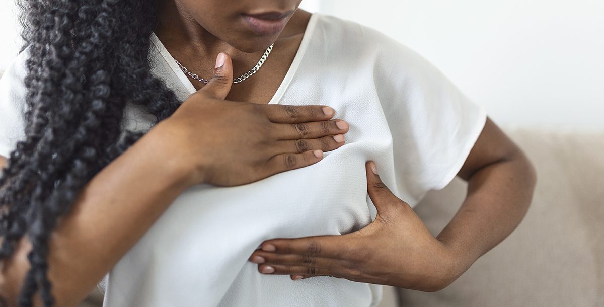 A woman performing a self breast-exam.