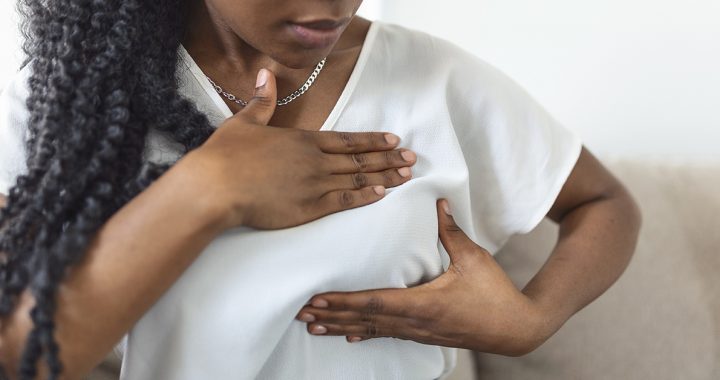 A woman performing a self breast-exam.