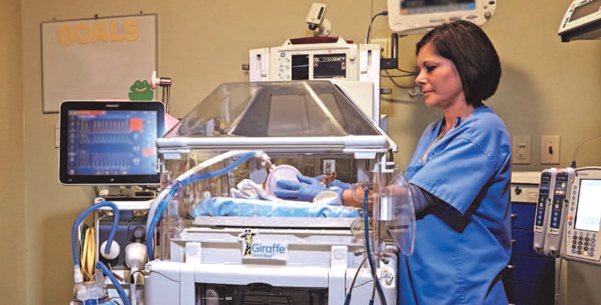 One of our NICU team members with a baby.