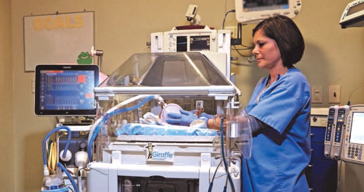 One of our NICU team members with a baby.