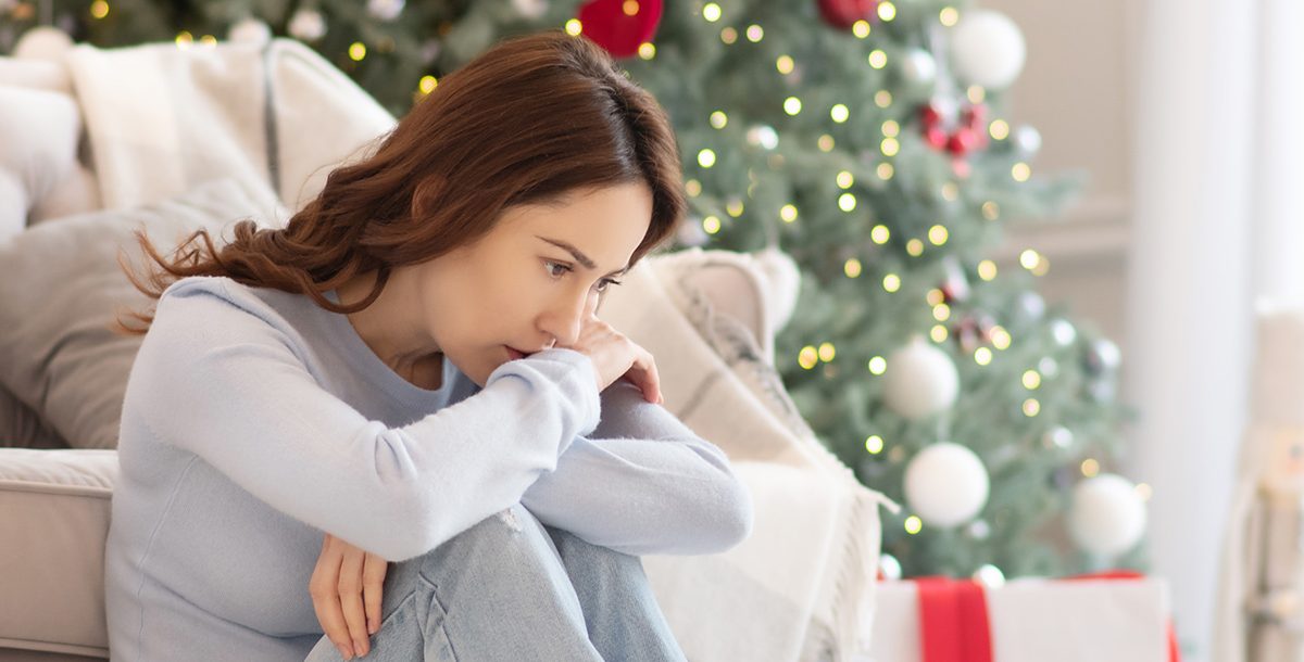 A woman experiencing holiday anxiety and depression.